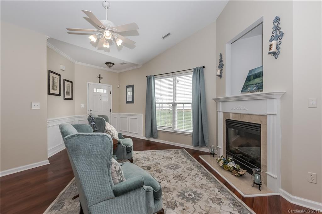 2531 Fossil Stone Lane Fort Mill, SC 29708 - Photo 3 of 21 a living room with furniture a chandelier and a fireplace