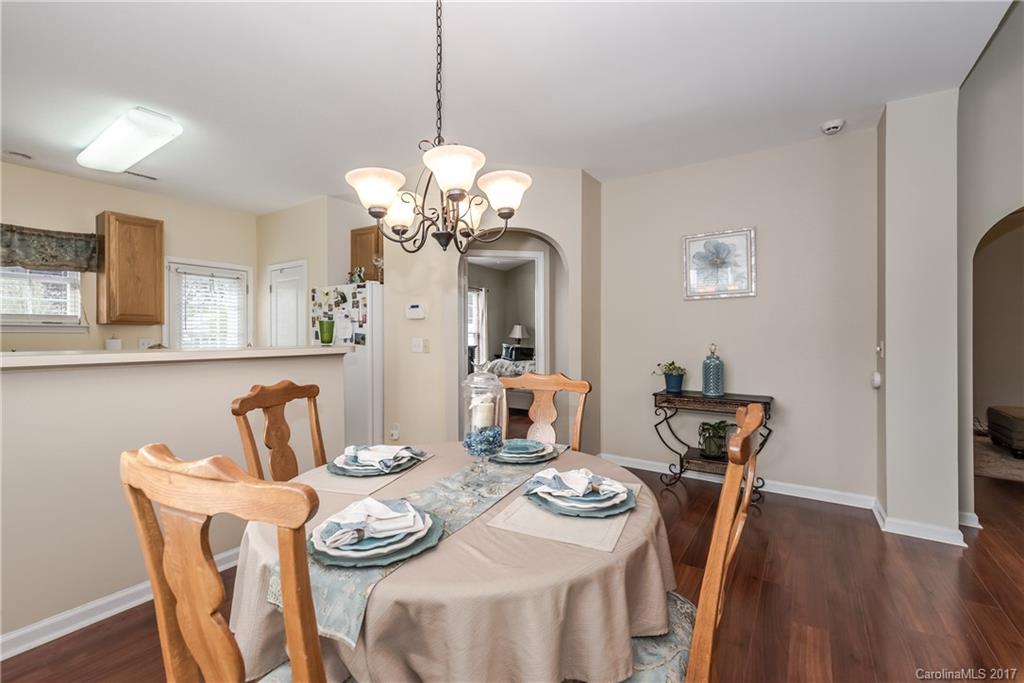 2531 Fossil Stone Lane Fort Mill, SC 29708 - Photo 8 of 21 a dining room with furniture a chandelier and wooden floor