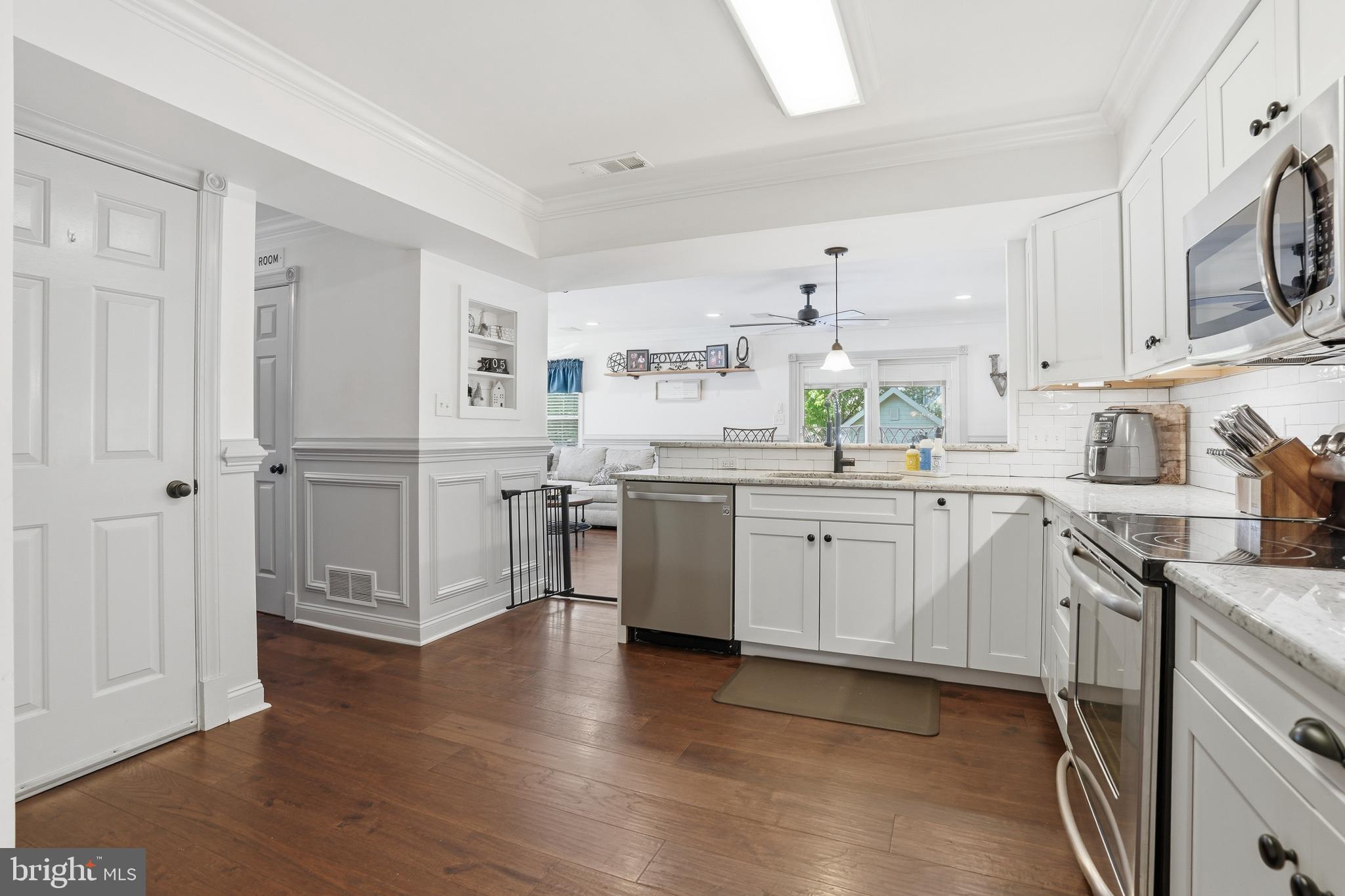 155 Nectar Run Telford, PA 18969 - Photo 12 of 32 a kitchen with stainless steel appliances sink cabinets and wooden floor