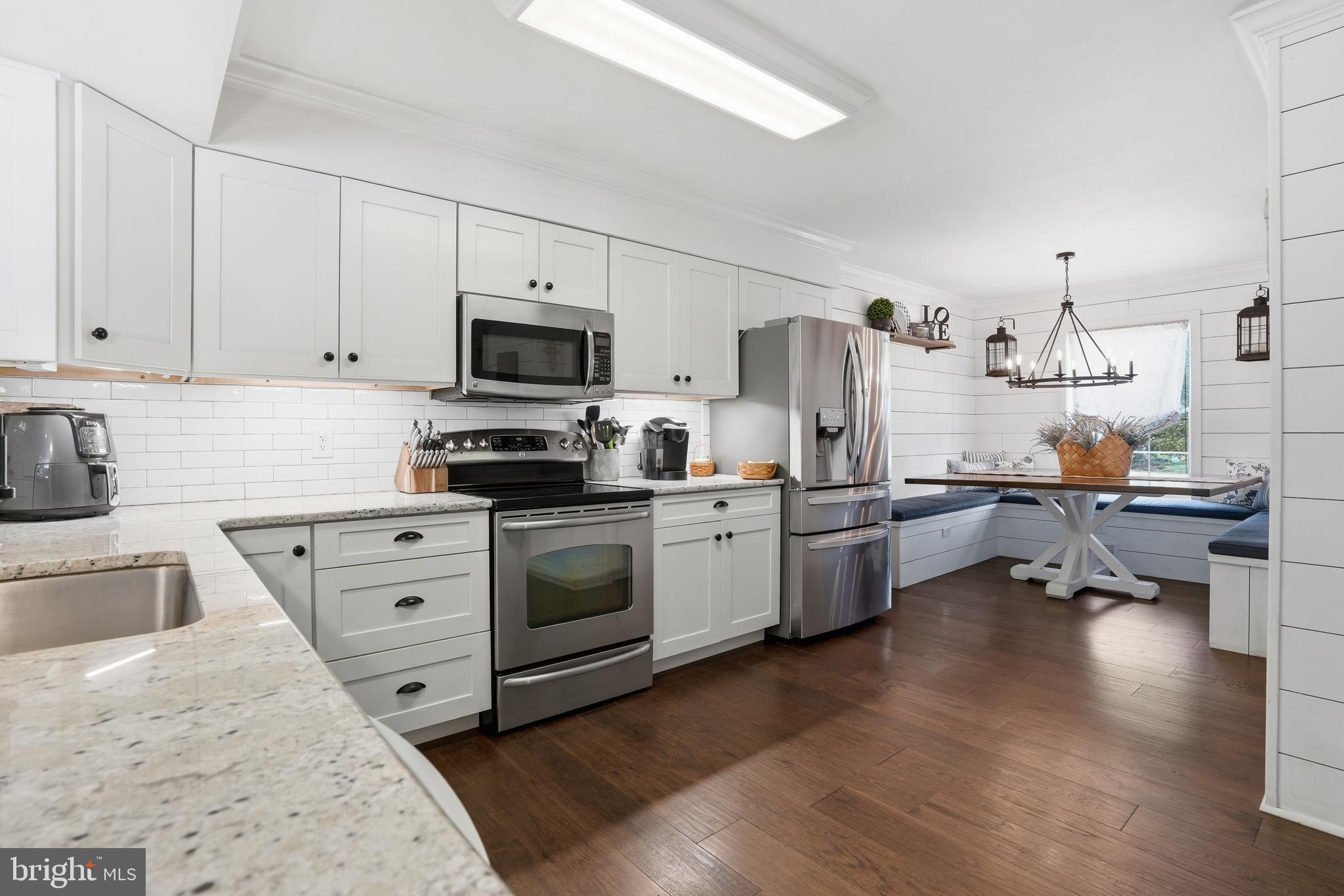 155 Nectar Run Telford, PA 18969 - Photo 8 of 32 a kitchen with kitchen island white cabinets and stainless steel appliances