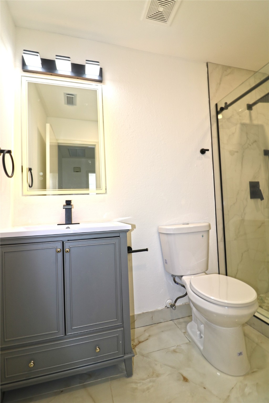 9611 Rads Point Sugar Land, TX 77498 - Photo 15 of 25 a bathroom with a toilet sink and mirror