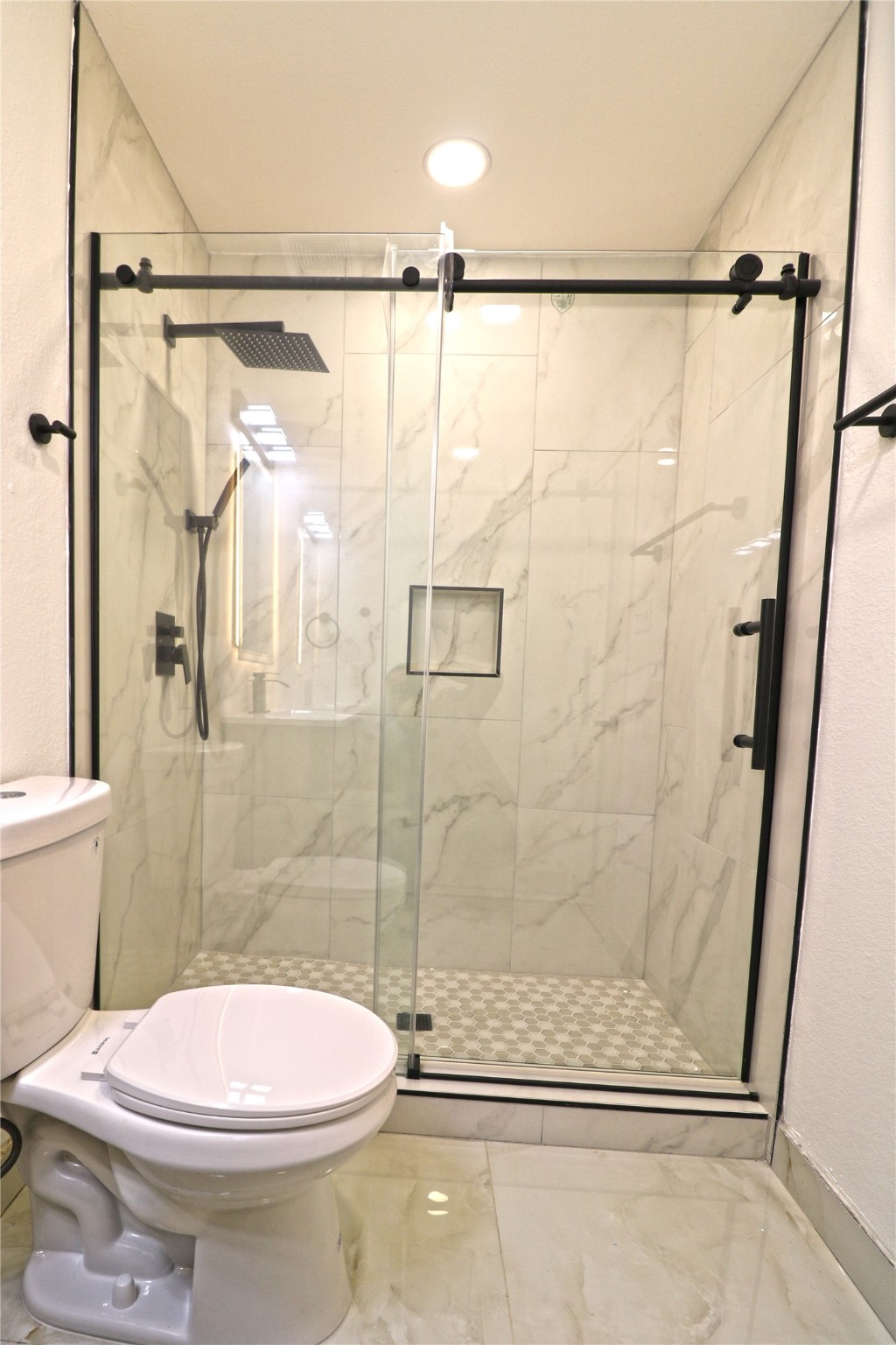 9611 Rads Point Sugar Land, TX 77498 - Photo 16 of 25 a bathroom with a shower and a toilet