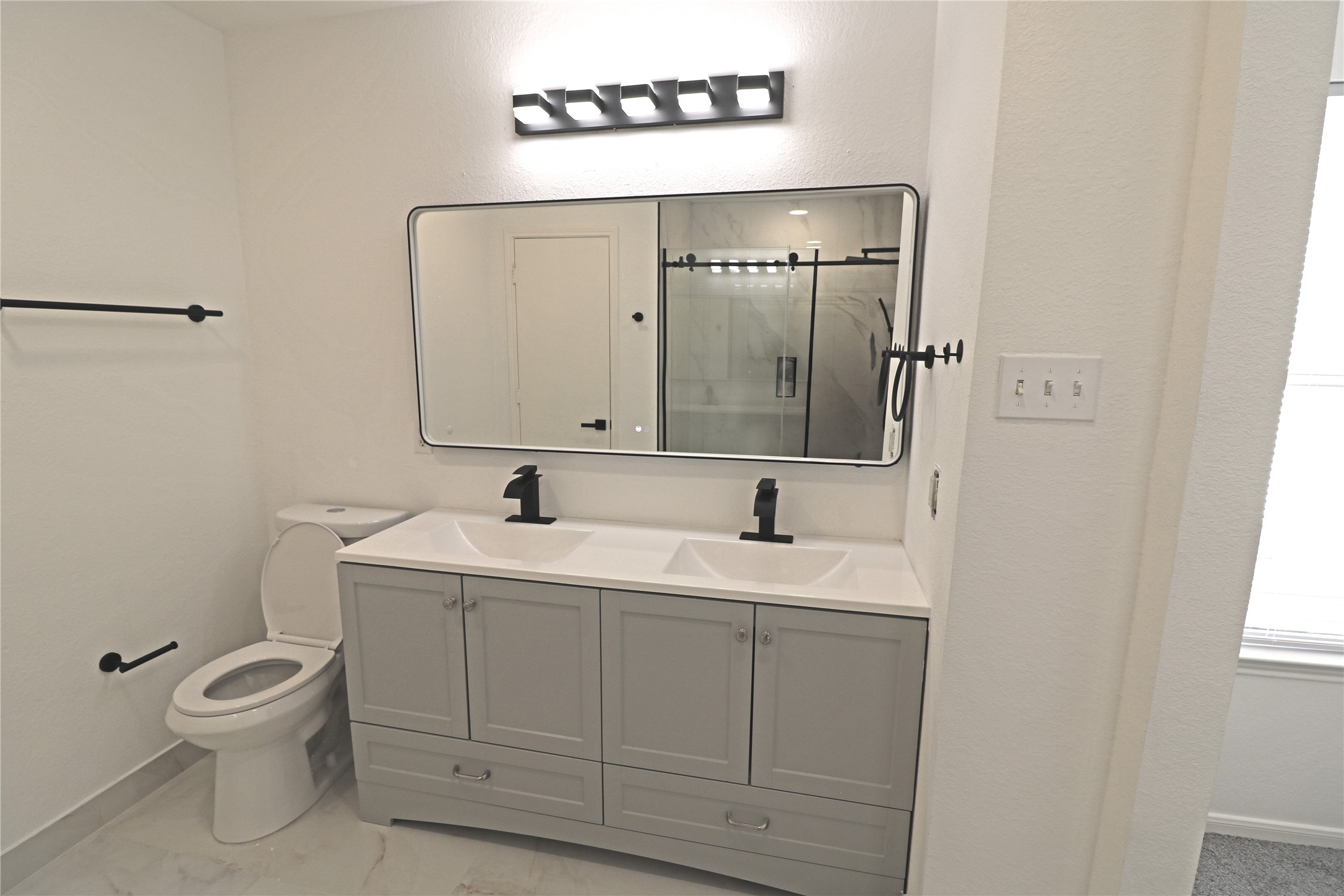 9611 Rads Point Sugar Land, TX 77498 - Photo 18 of 25 a bathroom with a toilet sink and mirror