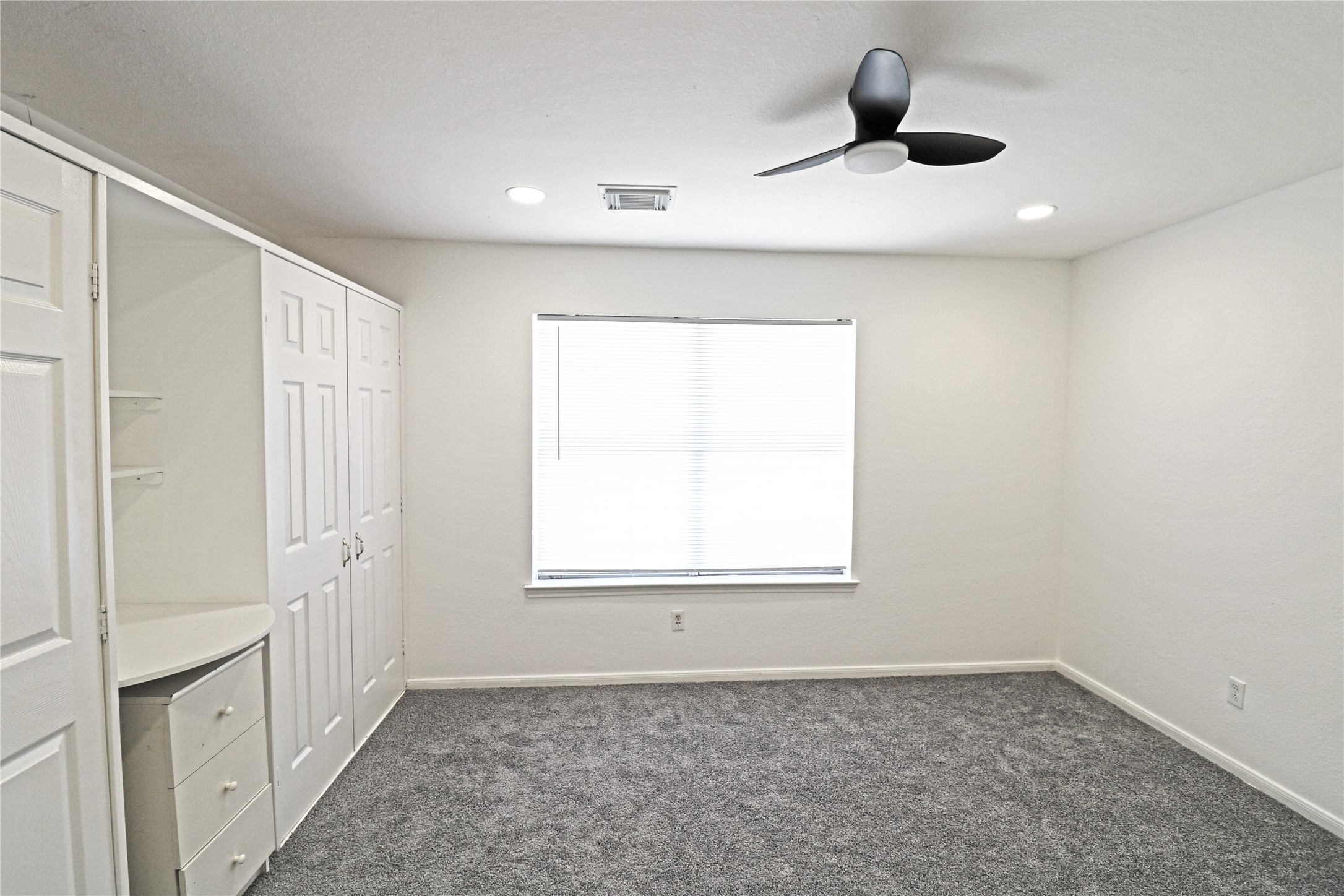 9611 Rads Point Sugar Land, TX 77498 - Photo 21 of 25 an empty room with a window and a ceiling fan