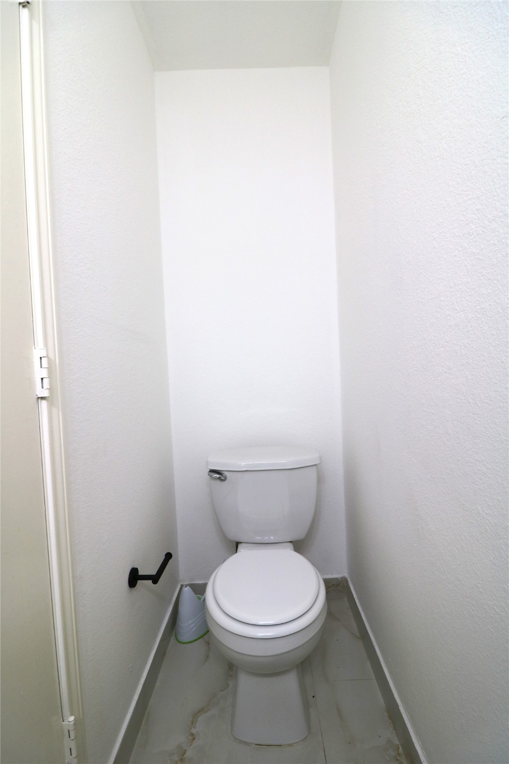 9611 Rads Point Sugar Land, TX 77498 - Photo 7 of 25 a white toilet sitting next to a white cabinet
