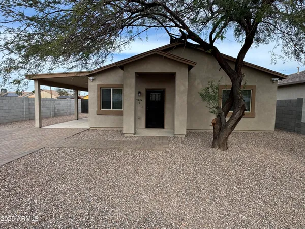 a house that has a tree in front of the house