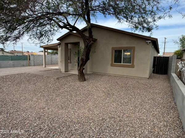 a house that has a tree in front of it