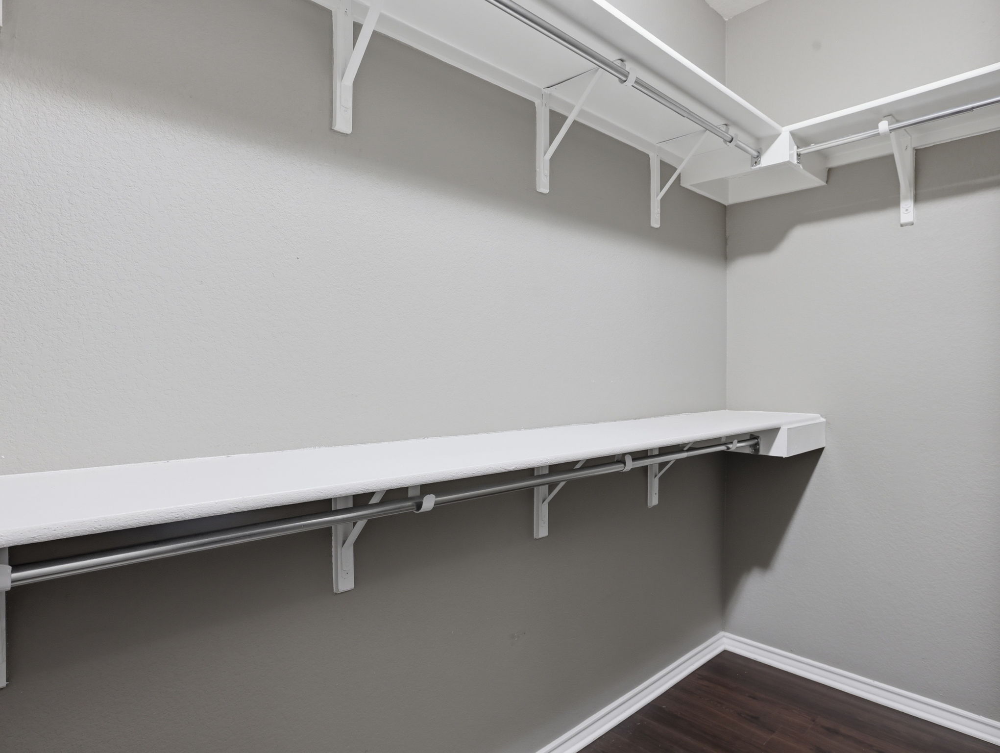 640 Landon Samuel Loop Pflugerville, TX 78660 - Photo 23 of 33 Custom closet system featuring white shelving, chrome hanging rods, and dark wood-finish flooring