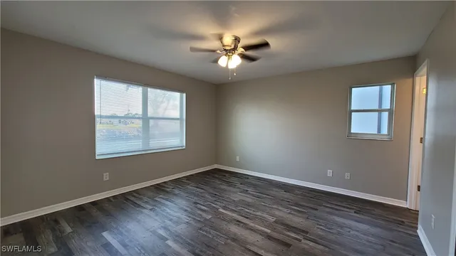 wooden floor in an empty room with a window