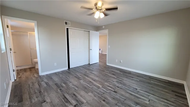 a kitchen with stainless steel appliances kitchen island granite countertop a refrigerator a sink a stove with cabinets