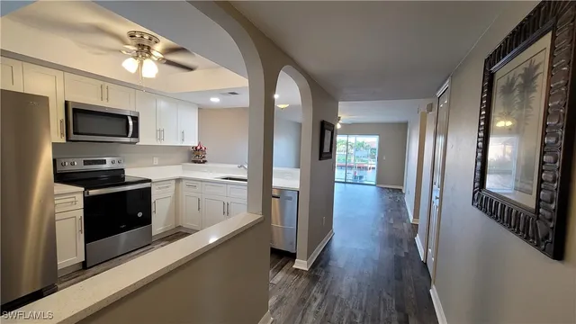 a kitchen with stainless steel appliances a refrigerator a stove microwave and sink