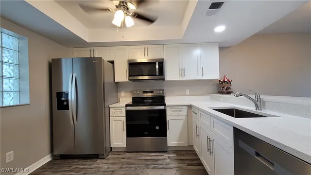a kitchen with a sink and stainless steel appliances