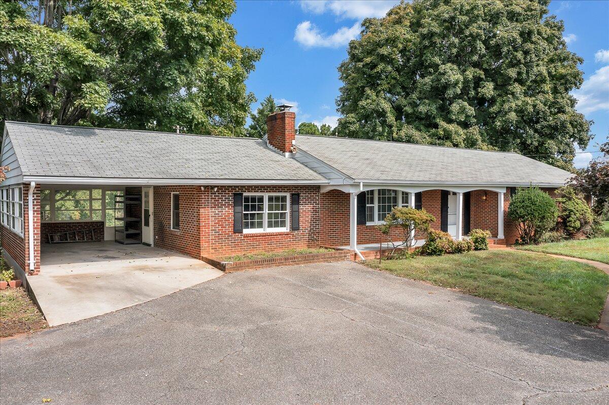 8450 Forest Road Goode, VA 24556 - Photo 2 of 49 a front view of a house with garden and porch