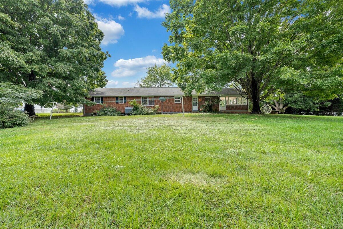 8450 Forest Road Goode, VA 24556 - Photo 15 of 49 a view of a house with a big yard and large trees