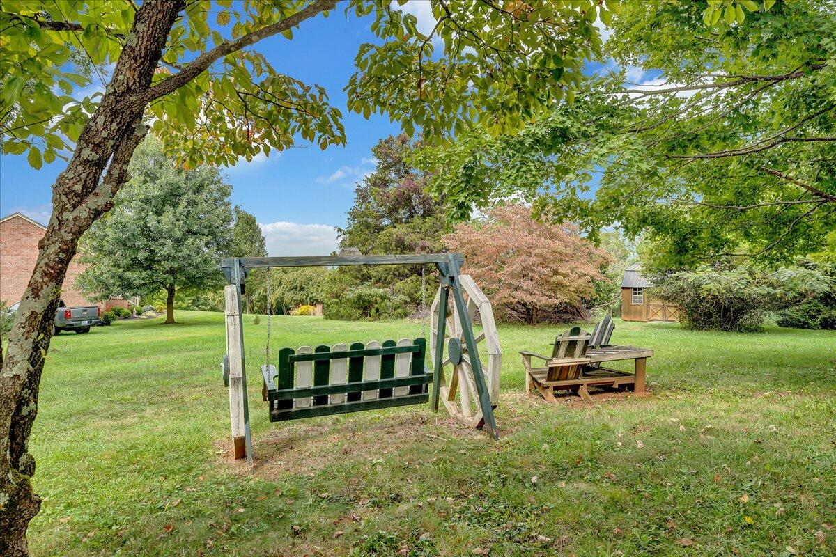 8450 Forest Road Goode, VA 24556 - Photo 17 of 49 a backyard of a house with table and chairs