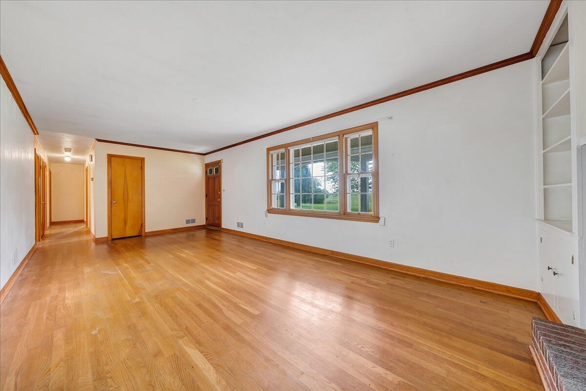 8450 Forest Road Goode, VA 24556 - Photo 28 of 49 a view of an empty room with wooden floor and a window