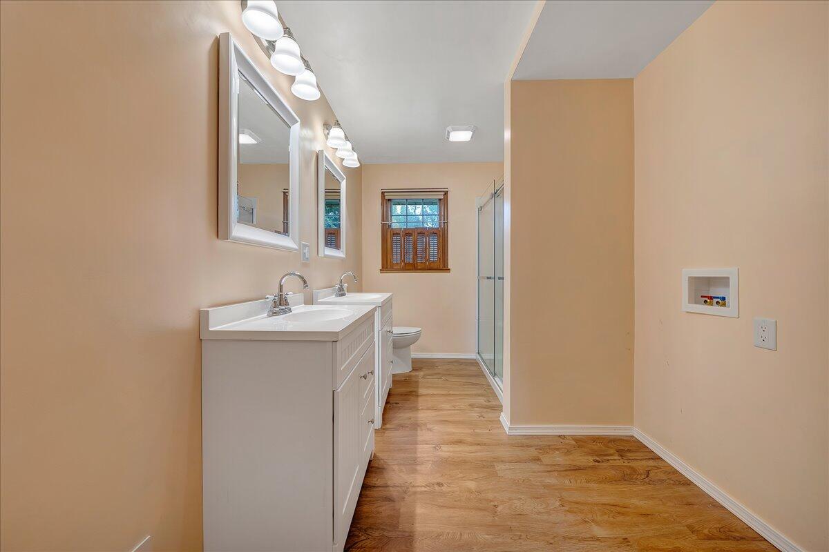 8450 Forest Road Goode, VA 24556 - Photo 36 of 49 a bathroom with a sink a mirror and a shower