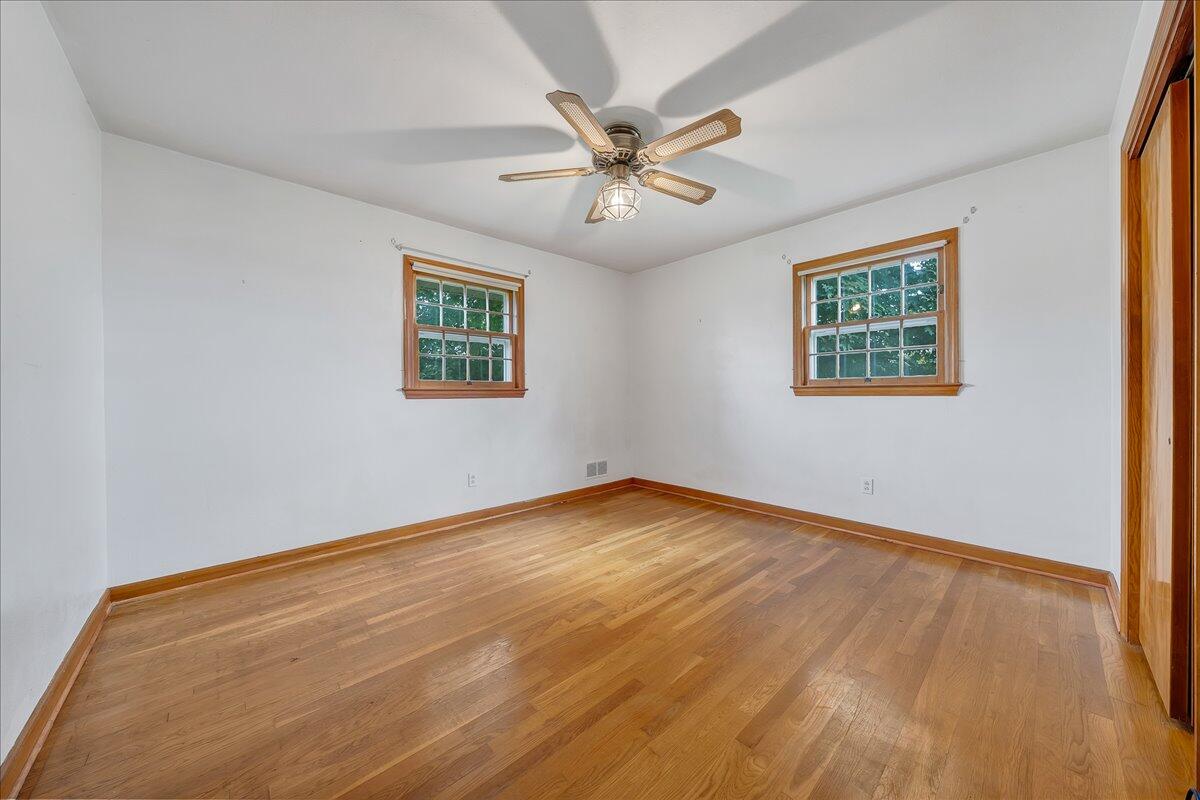 8450 Forest Road Goode, VA 24556 - Photo 38 of 49 a view of an empty room with wooden floor and a window