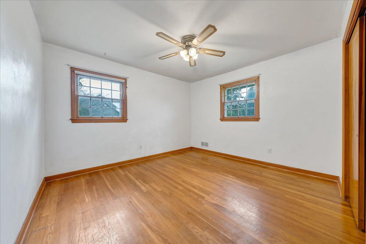 8450 Forest Road Goode, VA 24556 - Photo 42 of 49 a view of an empty room with wooden floor and a ceiling fan