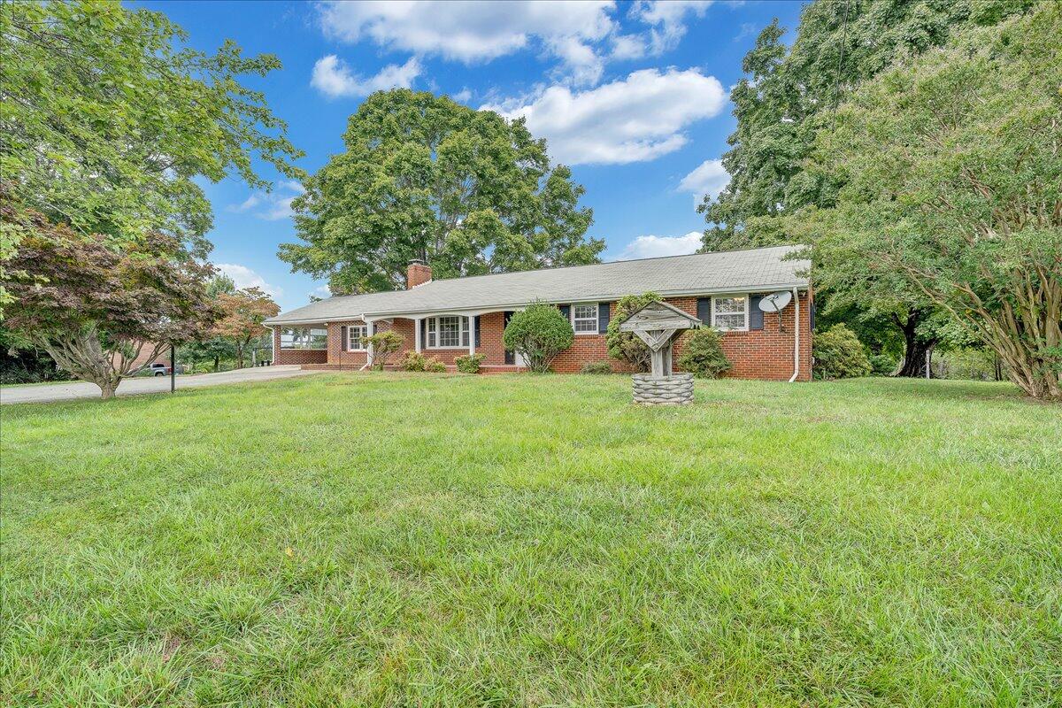 8450 Forest Road Goode, VA 24556 - Photo 6 of 49 a view of house with yard and trees in the background