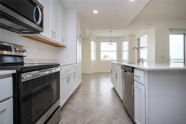 a kitchen with stainless steel appliances granite countertop a stove and a sink