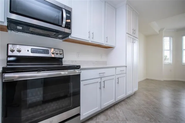 a stove top oven sitting inside of a kitchen