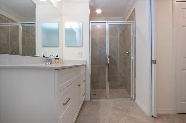 a bathroom with a shower sink and mirror