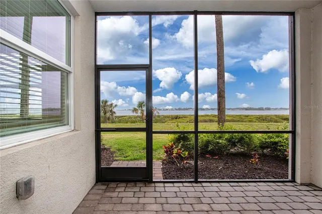 a view of a house with a swimming pool and sitting area