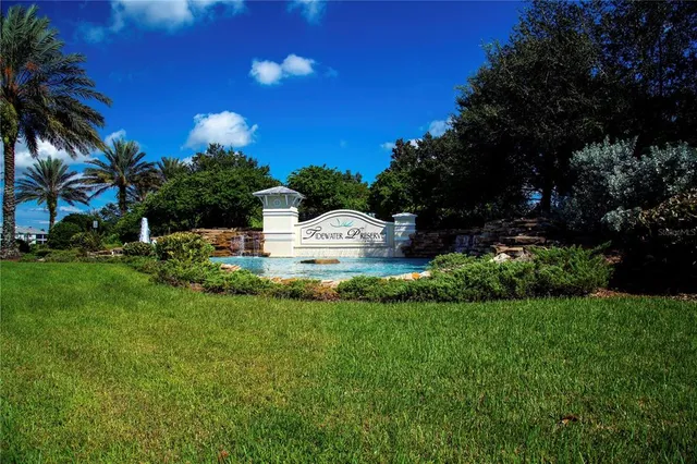 a front view of a house with garden and trees