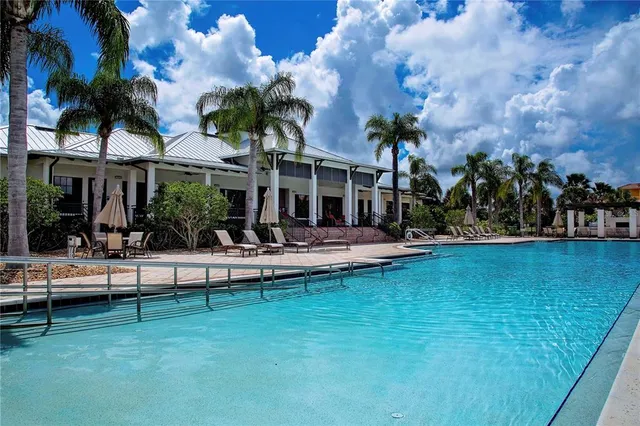a view of swimming pool with outdoor seating and plants