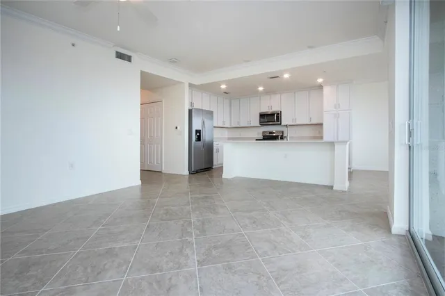 a view of a kitchen with refrigerator and a sink