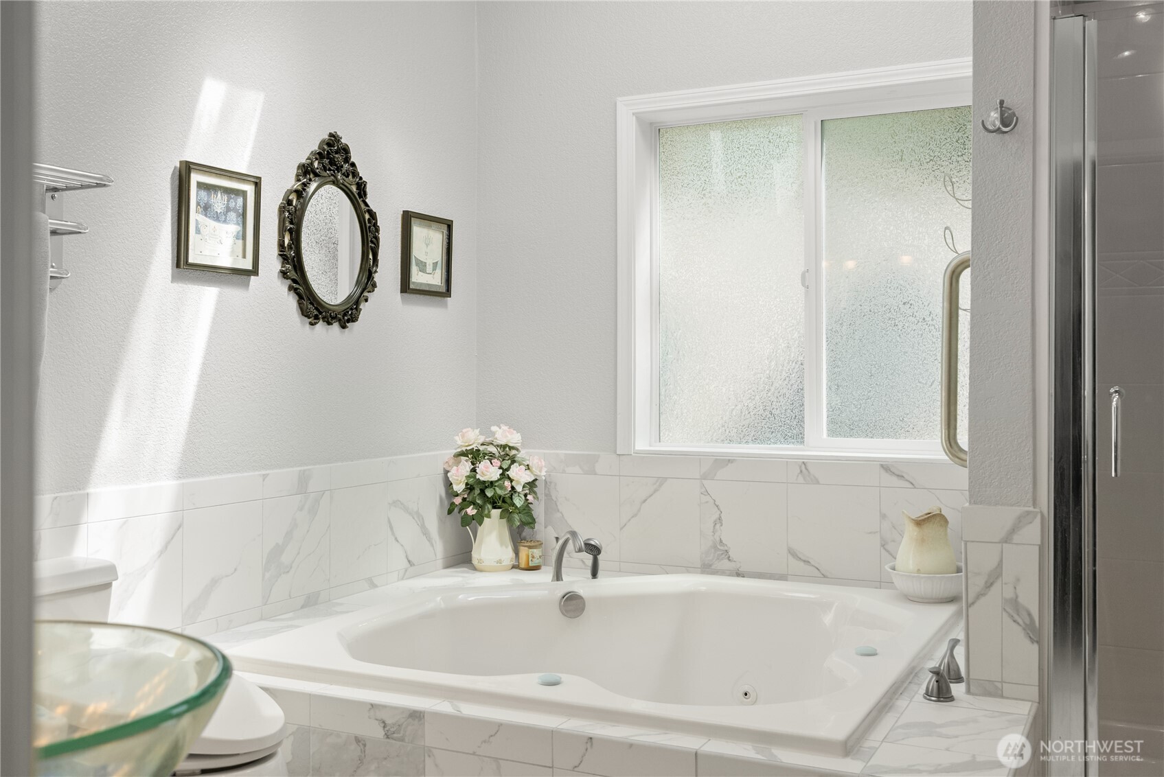 8320 East Grapeview Loop Road Allyn, WA 98524 - Photo 22 of 38 a white bath tub sitting next to a white toilet