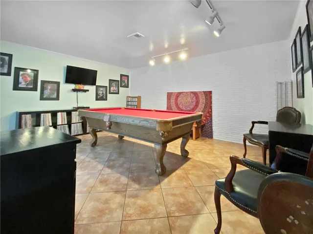 a living room with a table and a flat screen tv