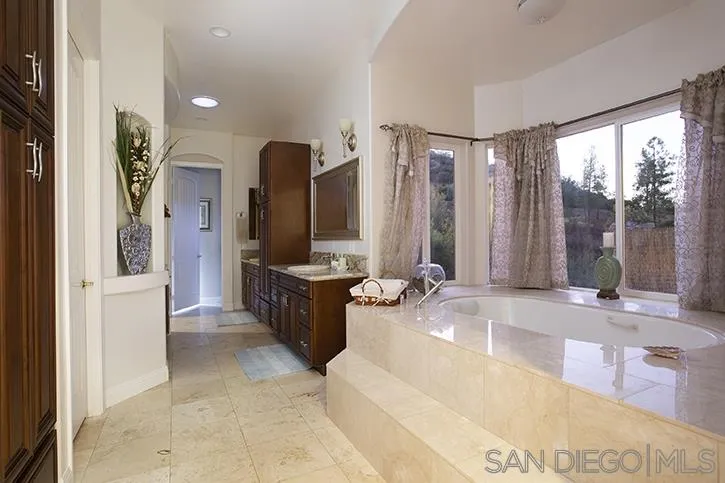2641 Firebrand Place Alpine, CA 91901 - Photo 15 of 25 a spacious bathroom with a tub sink and mirror