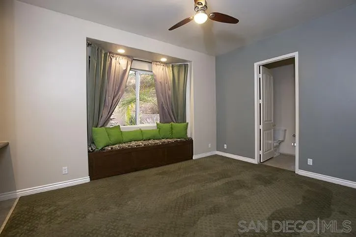 2641 Firebrand Place Alpine, CA 91901 - Photo 18 of 25 an empty room with a bed and a chandelier