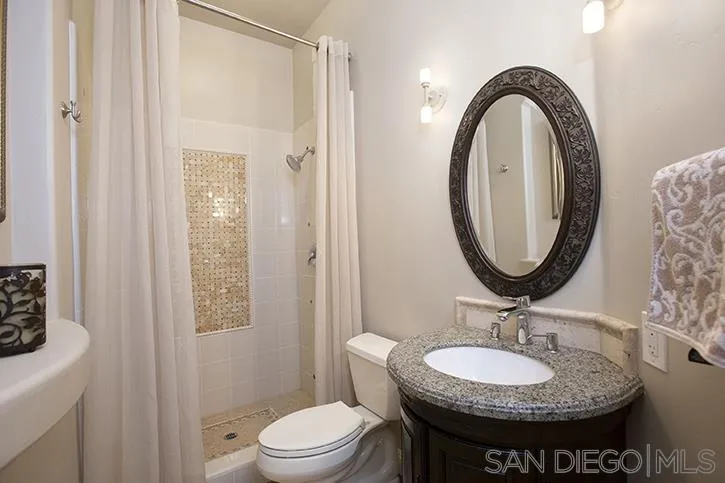 2641 Firebrand Place Alpine, CA 91901 - Photo 19 of 25 a bathroom with a sink a toilet and a mirror