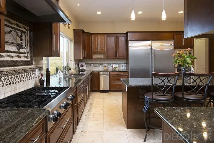 2641 Firebrand Place Alpine, CA 91901 - Photo 4 of 25 a kitchen with stainless steel appliances granite countertop a sink a stove and a refrigerator