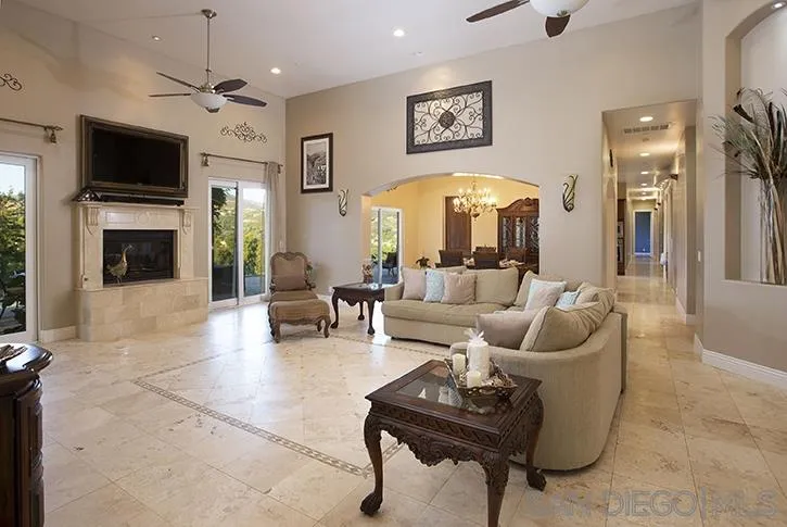 2641 Firebrand Place Alpine, CA 91901 - Photo 7 of 25 a living room with furniture a flat screen tv and a fireplace