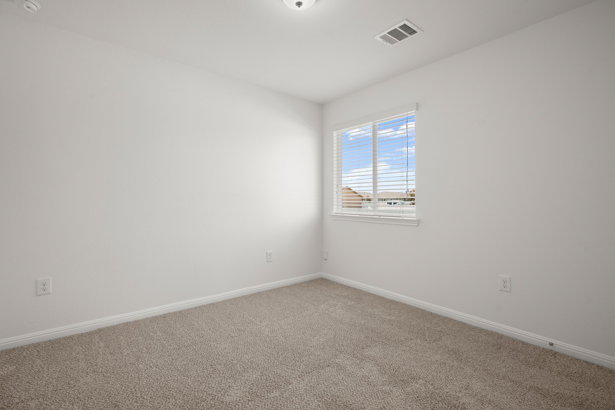 301 Cane River Road Pflugerville, TX 78660 - Photo 17 of 22 A well-lit room offers comfort with soft carpeting and natural light.
