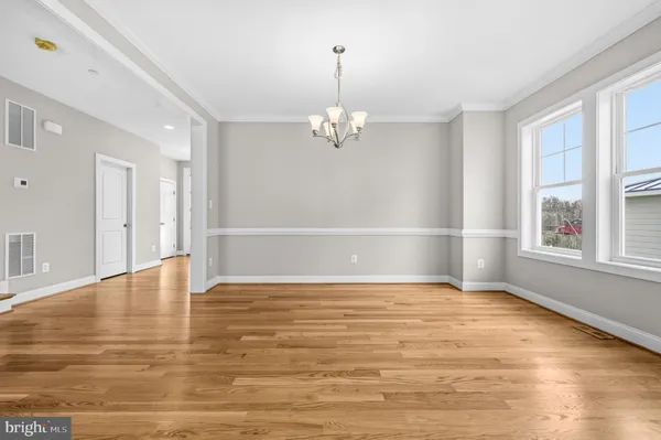 a view of a livingroom with wooden floor and a window