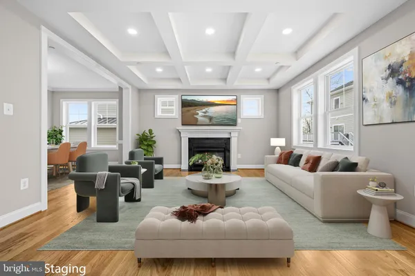 a living room with furniture fireplace and a large window