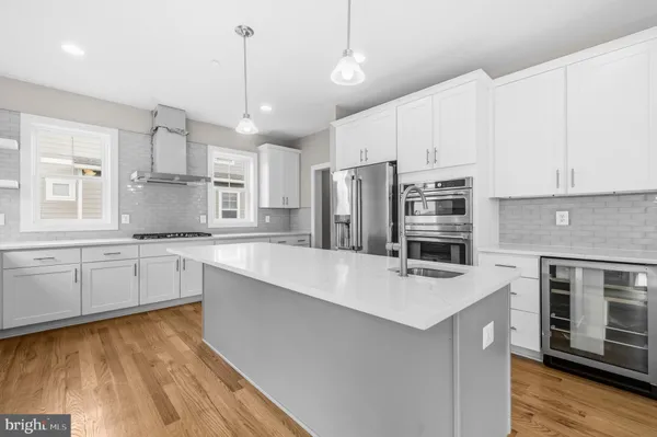 a kitchen with stainless steel appliances a stove sink and refrigerator