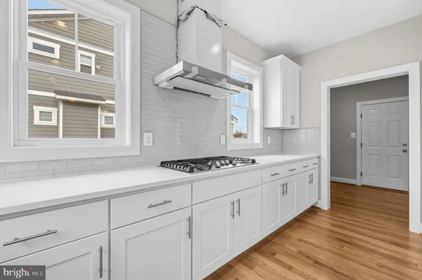 a kitchen with a sink cabinets and wooden floor