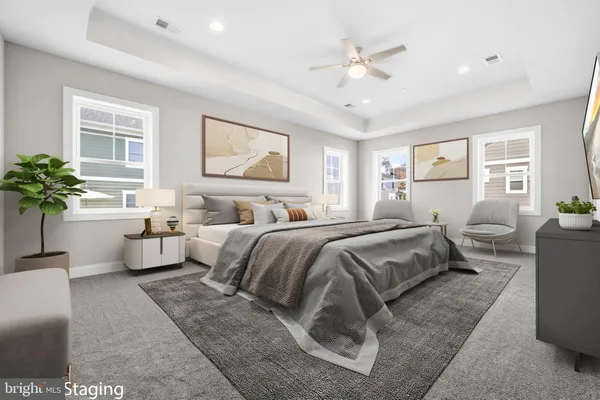 a spacious bedroom with a large bed and a chandelier