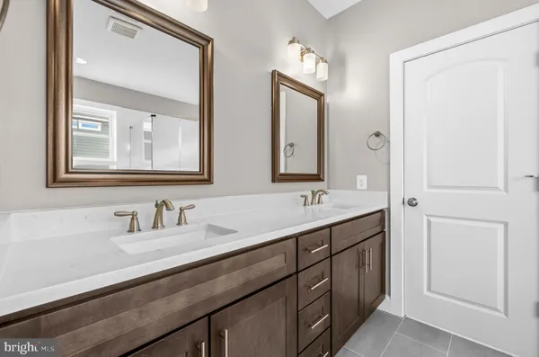 a bathroom with a double vanity sink and mirror