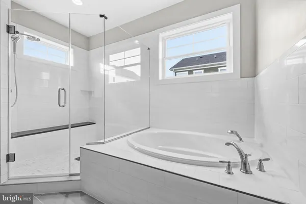a bathroom with a bathtub and a shower