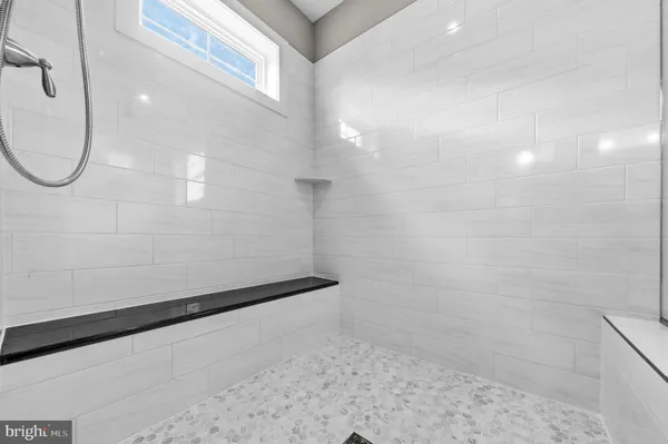 a bathroom with a glass shower door