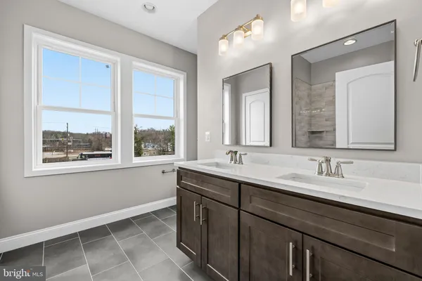 a bathroom with a double vanity sink and a mirror