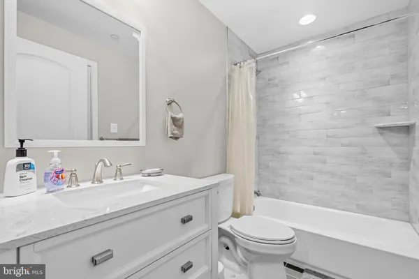 a bathroom with a sink a toilet and a bathtub