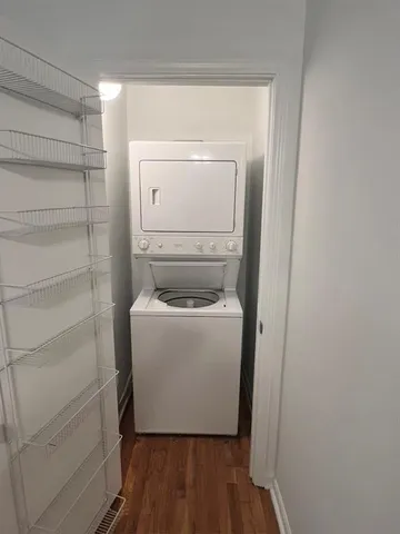 a utility room with wooden floor washer and dryer